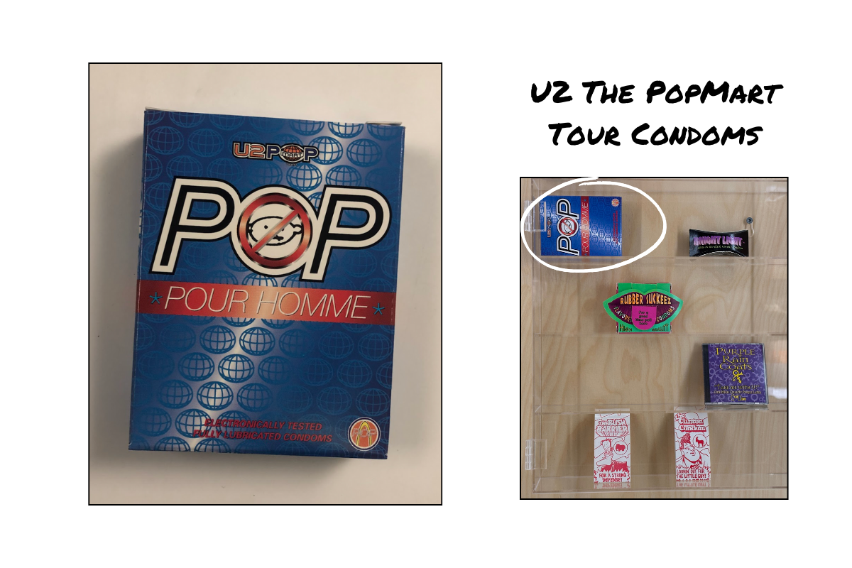 The image shows the U2 PopMart Tour Condoms. The package is blue and red, with text that says POP POUR TOMME. The image also shows the packaging in the display case at the Museum of Sex.